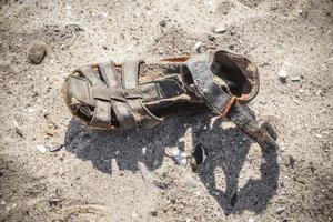 sapato vintage velho em uma praia de areia. foto