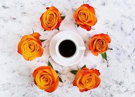 xícara de café e rosa em um fundo branco. vista do topo foto