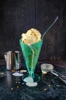 derretendo sorvete em copo alto com colher e granulado foto