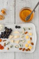 mistura de queijo e frutas no prato de cerâmico branco foto
