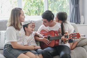 momentos felizes da família alegre asiática na casa de calor da sala de estar. conceito de relacionamento familiar de nova geração. conceito de estilo de vida familiar autêntico. foto