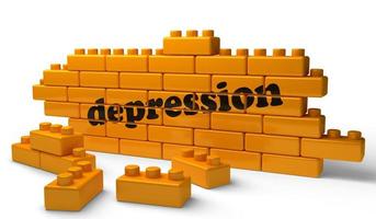 palavra de depressão na parede de tijolos amarelos foto