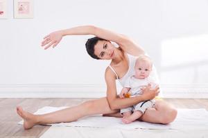 mãe e bebê saudáveis fazendo ginástica foto