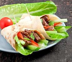 wraps de tortilha com carne e legumes frescos foto