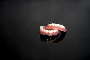 dentes humanos e modelo de anatomia da mandíbula para ilustração médica isolada em fundo preto com espaço de cópia para texto. dente saudável, atendimento odontológico e conceito ortodôntico. foto