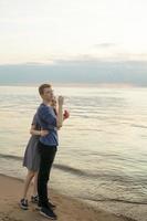 casal adolescente soprando bolhas de sopa na praia foto