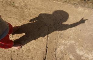 a sombra de uma criança em uma manhã ensolarada foto