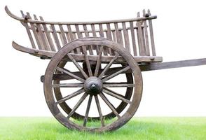 roda de carrinho com rodas de madeira velha no gramado. foto