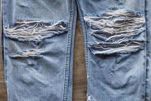 superfície da perna do jeans rasgada. foto