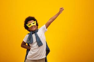 retrato de um menino jovem e mestiço vestido como um super-herói. bebê preto em traje de super-herói. o conceito de vencedor e sucesso. foto