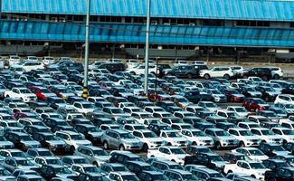 carro novo estacionado em uma fileira no estacionamento da fábrica. estoque de estoque do revendedor de automóveis. indústria automobilística. conceito de concessionária de carros. área de estacionamento de concreto para stock car após a linha de produção na fabricação. foto