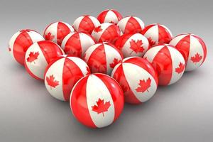 bolas 3d na cor da bandeira canadense com acabamento brilhante em um fundo cinza foto