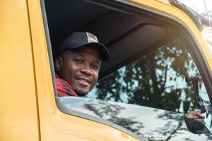 homem motorista de caminhão sorrindo confiante no transporte de carga de seguro foto