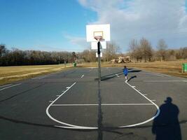 pai e filho sombras na quadra de basquete foto