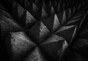 fundo de textura de arquitetura de concreto de ponta afiada. imagem de arte de padrão único de escultura em pedra escura em forma de triângulo pontiagudo. conceito de obstáculo no trabalho ou na vida. textura áspera da parede de concreto foto