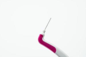 escova interdental com aperto de plástico branco e rosa isolado no fundo branco. escovas de dentes interdentais para higiene bucal. escovas de chaves. atendimento odontológico ou bom conceito de higiene dental. ferramentas médicas. foto