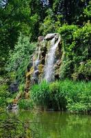 queda de água e um lago em palmen garten, frankfurt am main, hessen, alemanha foto