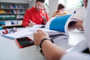 grupo de estudantes trabalhando no projeto escolar juntos no computador tablet na universidade moderna foto