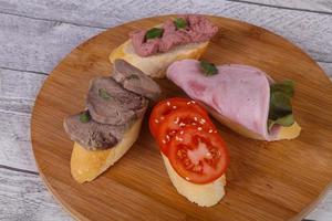 bruschetta com tomate, presunto e língua foto