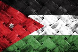 tela de bandeira da Jordânia em fundo de madeira de vime foto