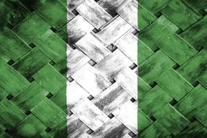 tela de bandeira da nigéria em fundo de madeira de vime foto
