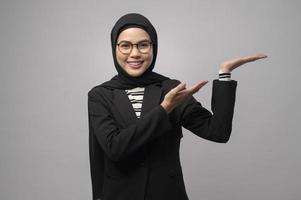 linda mulher muçulmana de óculos sobre estúdio de fundo branco foto
