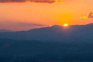 belo pôr do sol e céu dourado foto