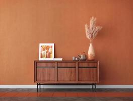 mesa de madeira na sala com pampas, porta-retrato e fundo de parede laranja. renderização em 3d foto