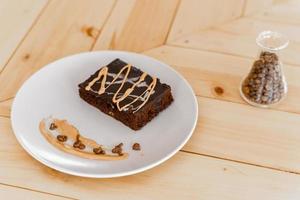 xícara de café cappuccino quente na mesa com bolo de chocolate foto