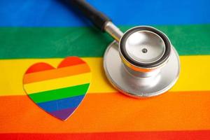 estetoscópio no fundo da bandeira do arco-íris, símbolo do mês do orgulho lgbt comemora anual em junho social, símbolo de gays, lésbicas, bissexuais, transgêneros, direitos humanos e paz. foto