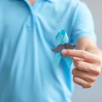 novembro mês de conscientização do câncer de próstata, homem segurando fita azul com bigode para apoiar pessoas que vivem e doenças. cuidados de saúde, homens internacionais, pai e conceito de dia mundial do câncer foto