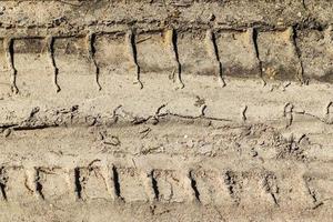 vista detalhada de perto em terrenos agrícolas secos com marcas de pneus em alta resolução foto