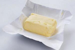 fatia de manteiga em um papel na mesa