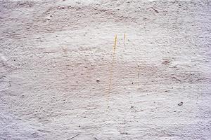 textura de uma parede de concreto com rachaduras e arranhões que podem ser usados como pano de fundo foto