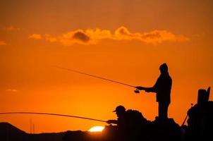silhueta de vara de pesca de pescador foto
