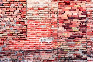 textura de uma parede de tijolos com rachaduras e arranhões que podem ser usados como pano de fundo foto