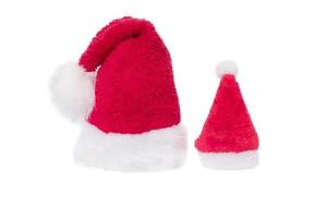 vermelho com o conceito de Natal de chapéu de Papai Noel branco. comemorando o natal ou ano novo. chapéu de papai noel pequeno e grande. foto