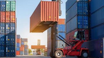 empilhadeira trabalhando no porto do pátio de carga de contêineres, carregando o serviço logístico e o conceito de transporte do tanque de carga. foto