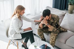 transtorno de estresse pós-traumático. soldado tem sessão de terapia com psicólogo dentro de casa foto