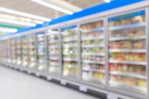 congelador de geladeiras comerciais de supermercado mostrando fundo desfocado abstrato de alimentos congelados foto