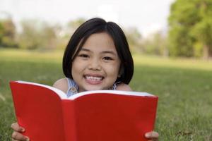 menina asiática lendo livro foto