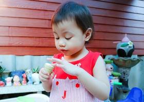 encantadora menina asiática de 3 anos de idade, criança pequena com adorável franja escura. foto