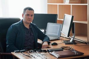 retrato de examinador de polígrafo profissional no escritório com o equipamento de seu detector de mentiras foto