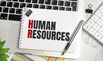recursos Humanos . texto em papel branco e laptop em fundo de madeira foto