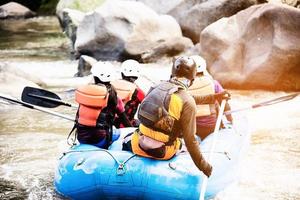 pessoas jogando atividade de esporte de aventura de jangada no rio foto