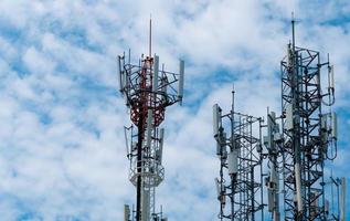 torre de telecomunicações com fundo de céu azul e nuvens brancas. antena no céu azul. poste de rádio e satélite. tecnologia de comunicação. indústria de telecomunicações. rede 4g móvel ou de telecomunicações. foto