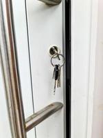 abra a porta do apartamento com uma chave na fechadura - segurança e proteção contra roubo. foto