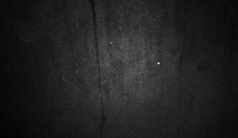 conceito de fundo de halloween de parede escura e preta. concreto preto empoeirado para segundo plano. textura de cimento de terror foto
