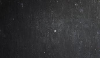 conceito de fundo de halloween de parede escura e preta. concreto preto empoeirado para segundo plano. textura de cimento de terror foto
