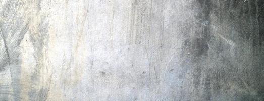 velho muro de concreto sujo como pano de fundo. gesso de cimento cinza. textura de parede para plano de fundo. escova arranhões na parede foto